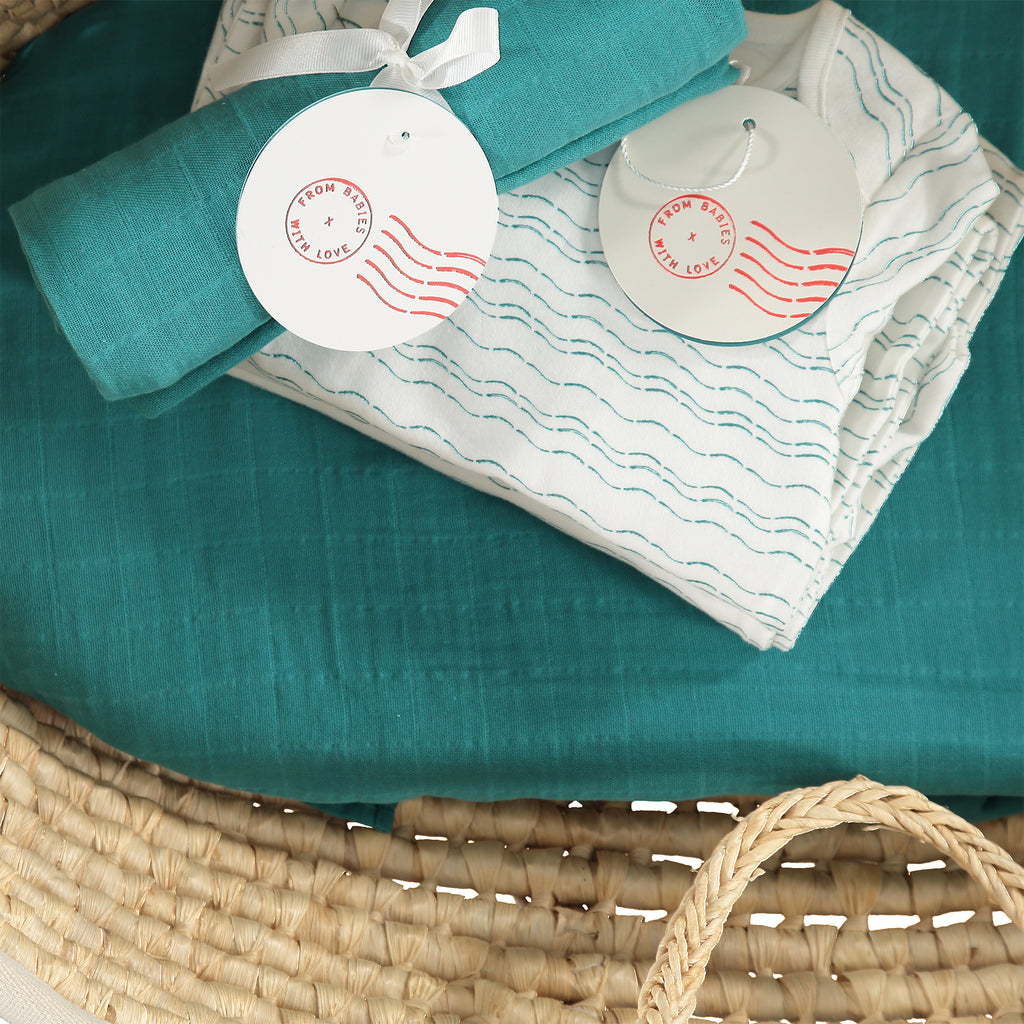 Baby basket - Teal organic baby gift set - large - Send love and kindness with our Waves of Joy organic baby grow, knot hat, bandana bib and muslin swaddling wrap, a heartfelt and beautiful baby gift. 